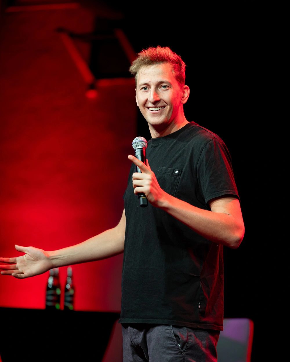 Piotrek Szumowski na scenie trzymający mikrofon